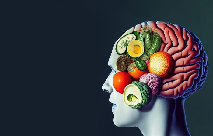Side view of a human head with a brain shaped from colorful fruits and vegetables, symbolizing brain health and nutrition
