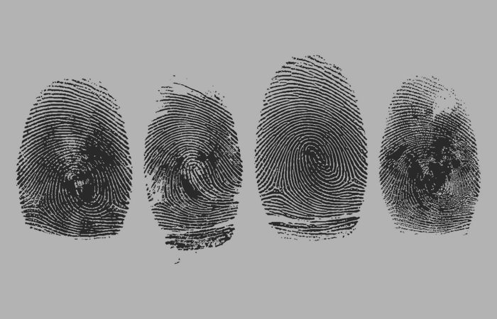 Four black fingerprint impressions lined up on a gray background.