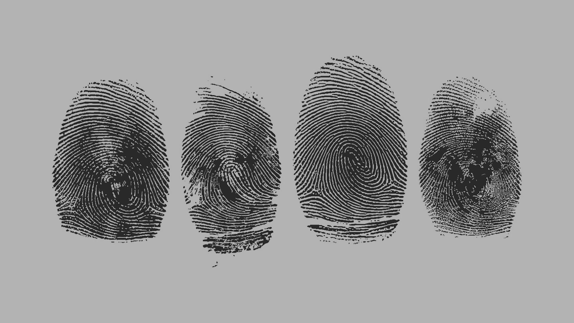 Four black fingerprint impressions lined up on a gray background.