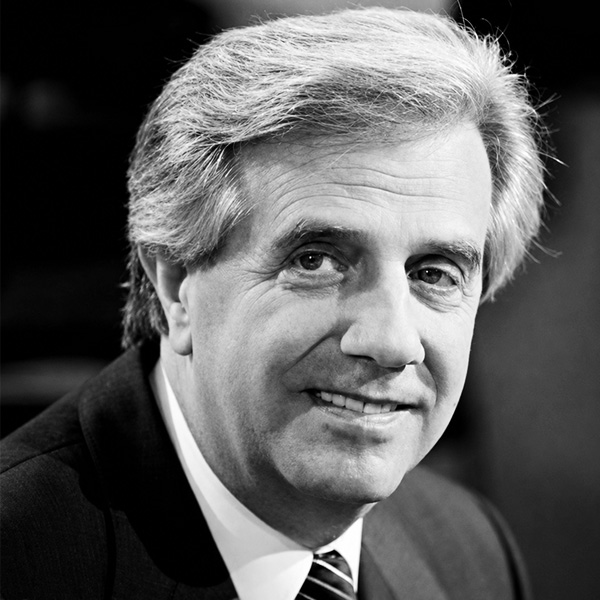 Black-and-white portrait of a smiling middle-aged man in a suit and tie.